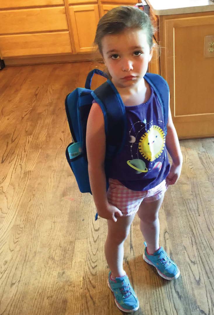 CHILD WEARING BACKPACK