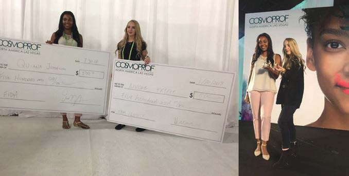 two girls holding large checks