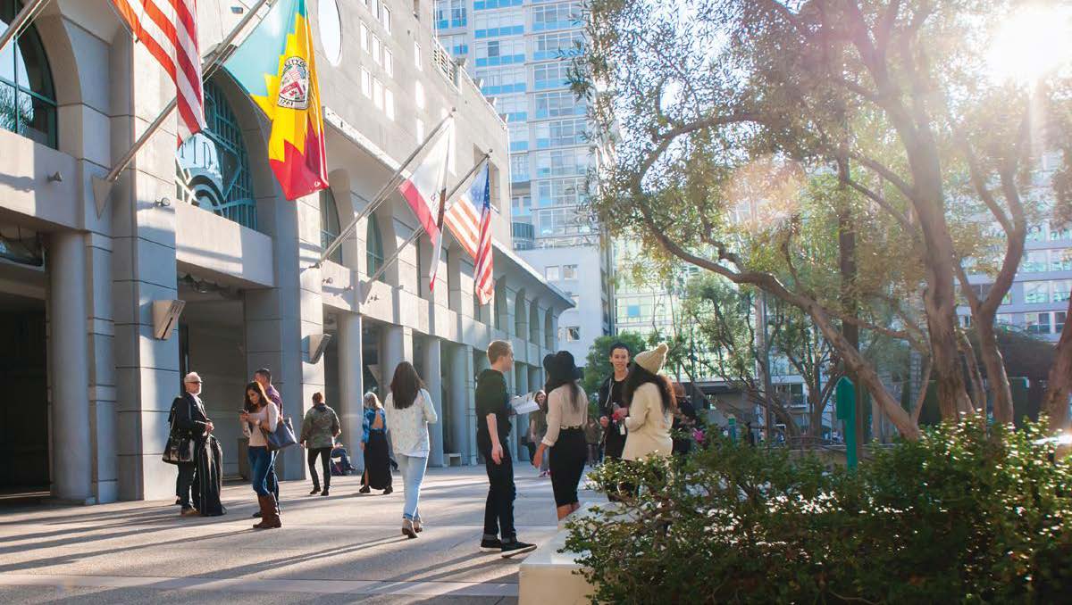 people in front of building talking