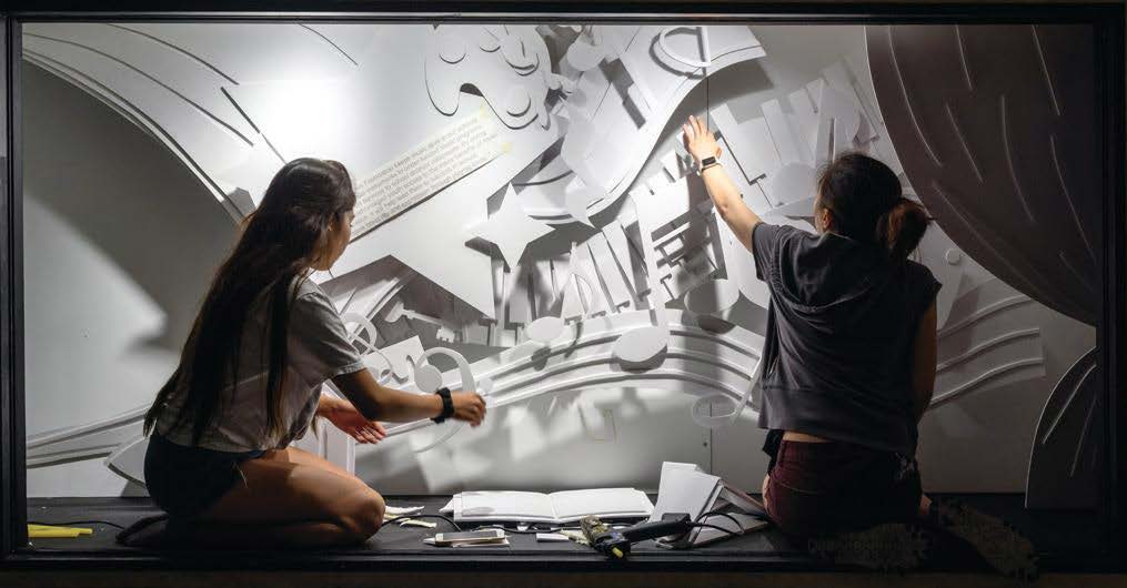 two girls designing a wall mural