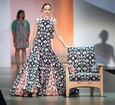 women in dress next to chair with same fabric