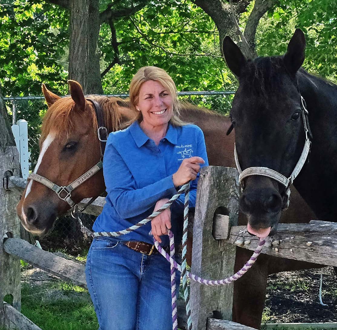 LISA GATTI STANDING WITH TWO HORSES