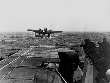 BLACK AND WHITE PHOTO OF WW2 PLANE TAKING OFF FROM AN AIRCRAFT CARRIER